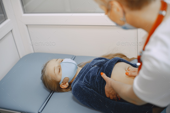 Little girl and the doctor for a checkup examined stock